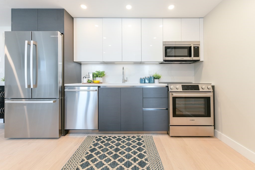 932 Broadway, Unit 212 Chelsea, MA 02150 - Photo 1 of 35 a kitchen with a refrigerator sink and microwave