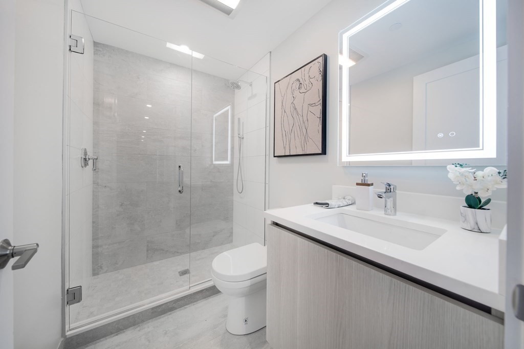932 Broadway, Unit 212 Chelsea, MA 02150 - Photo 18 of 35 a bathroom with a sink toilet and shower