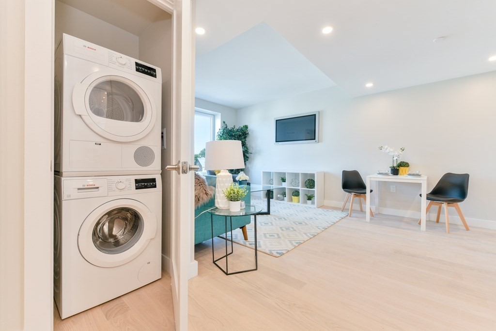 932 Broadway, Unit 212 Chelsea, MA 02150 - Photo 23 of 35 a living room with furniture and a washing machine