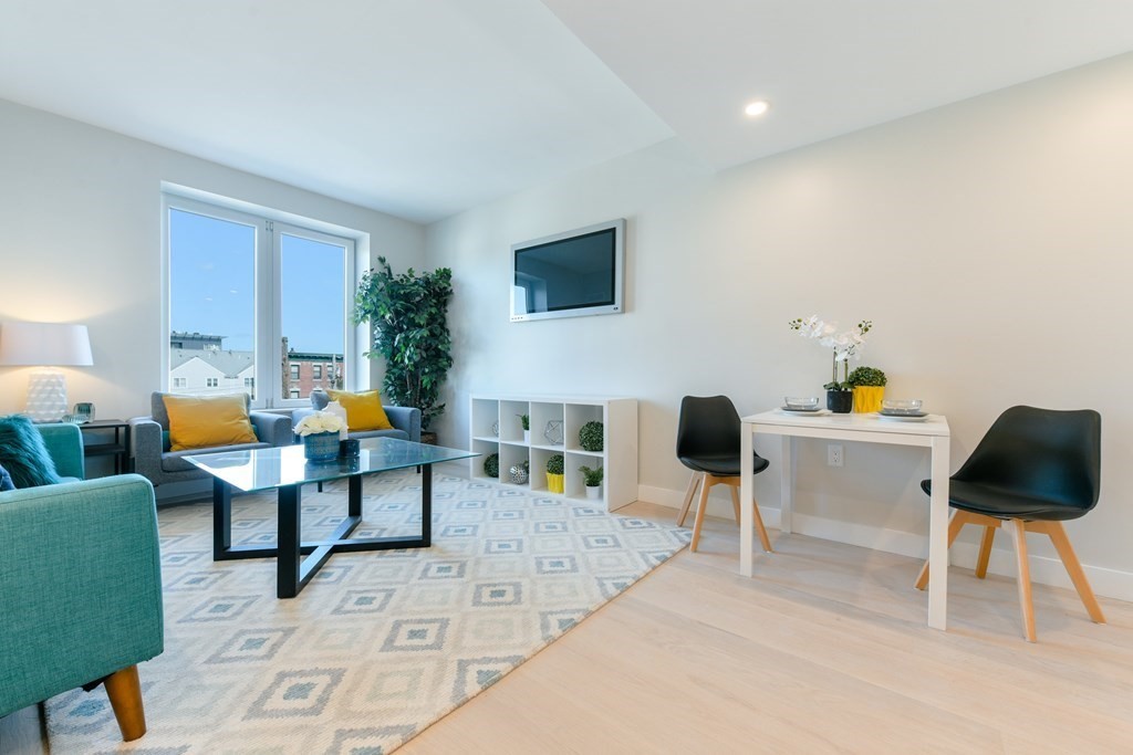 932 Broadway, Unit 212 Chelsea, MA 02150 - Photo 26 of 35 a living room with furniture and a flat screen tv