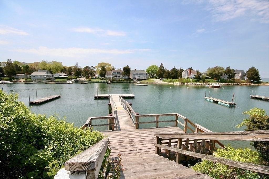 189 Tahanto Road Bourne, MA 02559 - Photo 13 of 24 a view of a lake with a wooden bridge