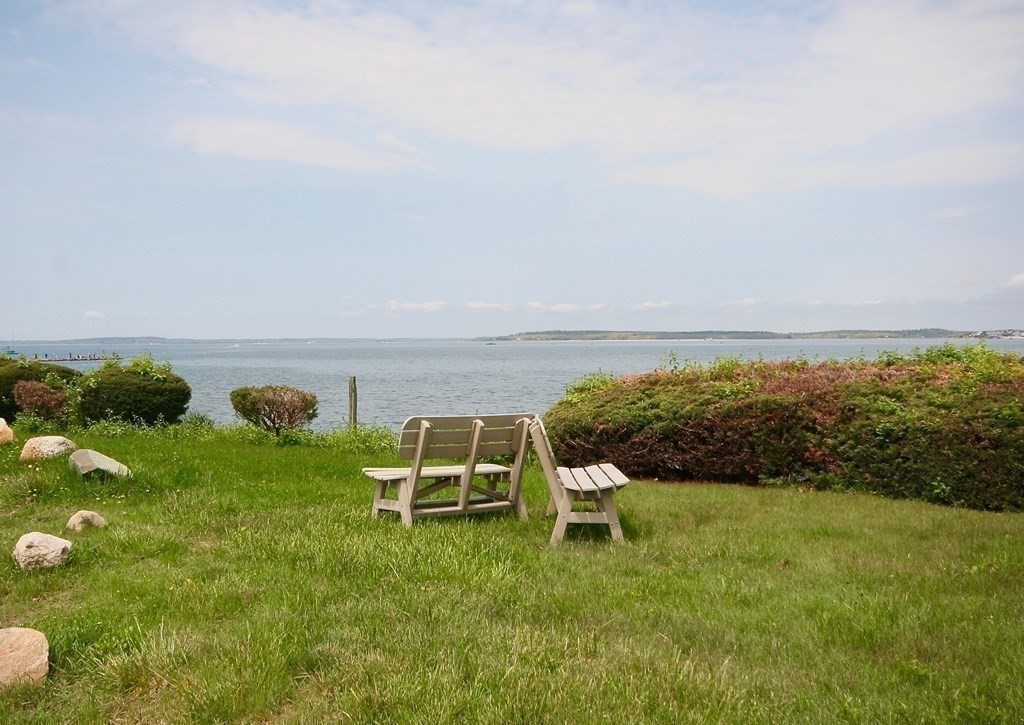 189 Tahanto Road Bourne, MA 02559 - Photo 14 of 24 a lawn chairs sitting in the middle of a lake