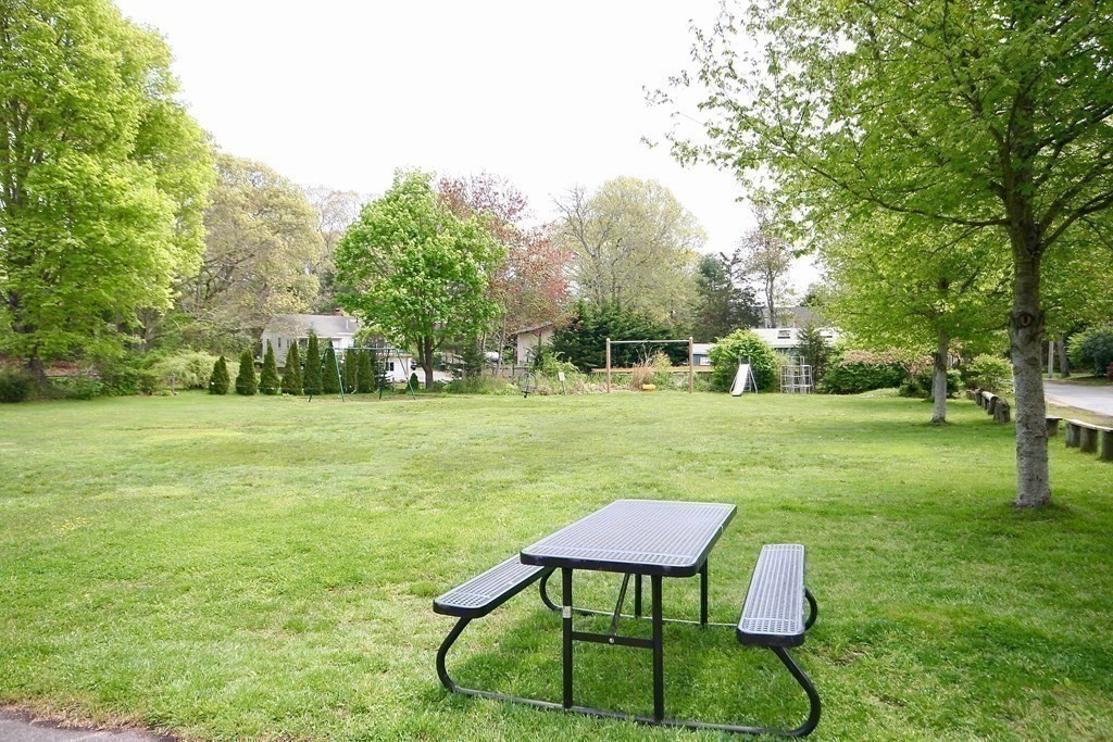189 Tahanto Road Bourne, MA 02559 - Photo 16 of 24 a view of a table and chairs in the garden