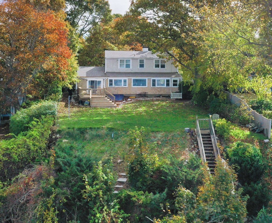 189 Tahanto Road Bourne, MA 02559 - Photo 3 of 24 a front view of a house with a yard table and chairs