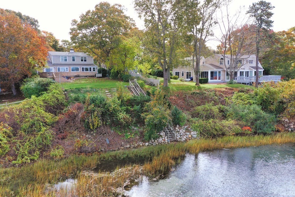 189 Tahanto Road Bourne, MA 02559 - Photo 5 of 24 a view of a house with a yard and a wooden fence