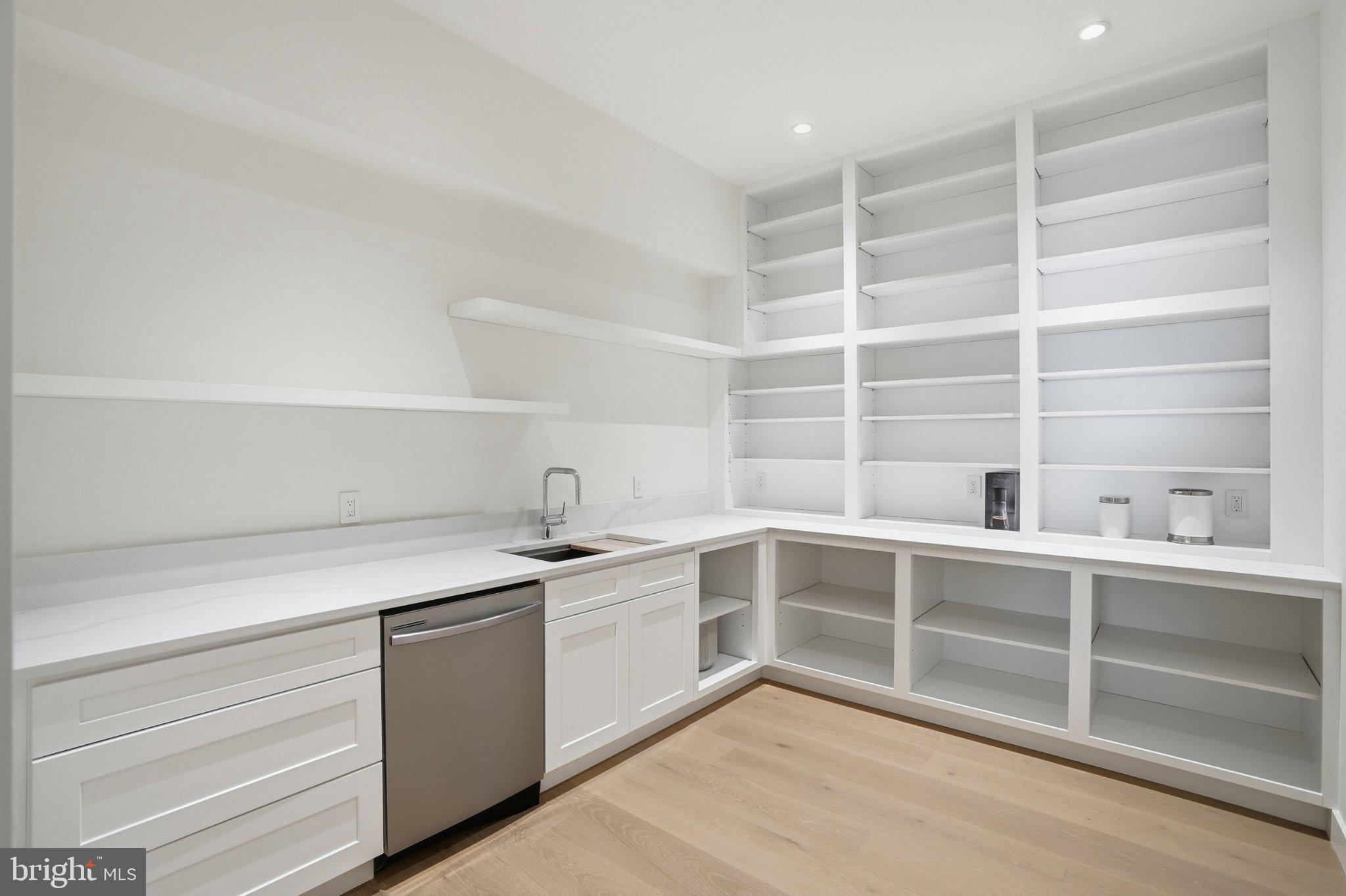 7421 Magarity Road Falls Church, VA 22043 - Photo 36 of 66 Sleek, modern kitchen with open shelves.