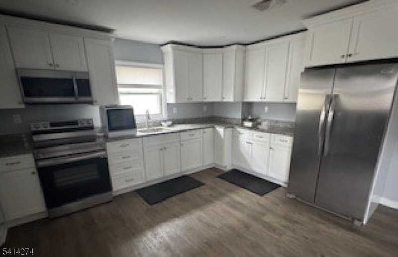 11 Main Street Sparta, NJ 07871 - Photo 3 of 10 a kitchen with stainless steel appliances granite countertop a stove a sink and a refrigerator