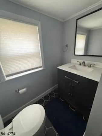 a bathroom with a toilet sink vanity and mirror
