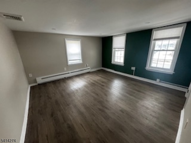 11 Main Street Sparta, NJ 07871 - Photo 8 of 10 an empty room with wooden floor and windows