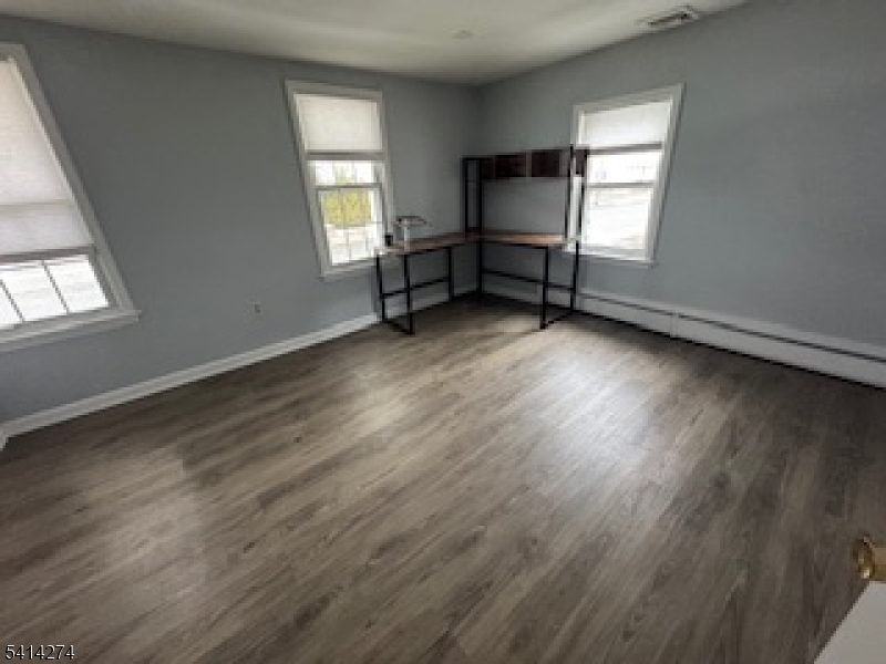 11 Main Street Sparta, NJ 07871 - Photo 9 of 10 an empty room with wooden floor and windows