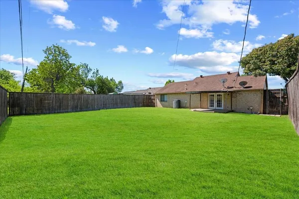 a view of an house with backyard space and garden
