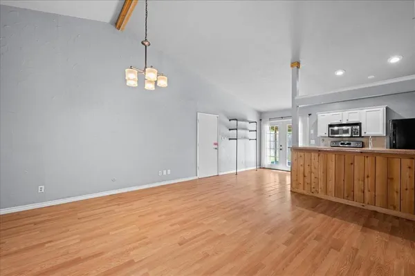 a view of a kitchen with a dishwasher cabinets and wooden floor