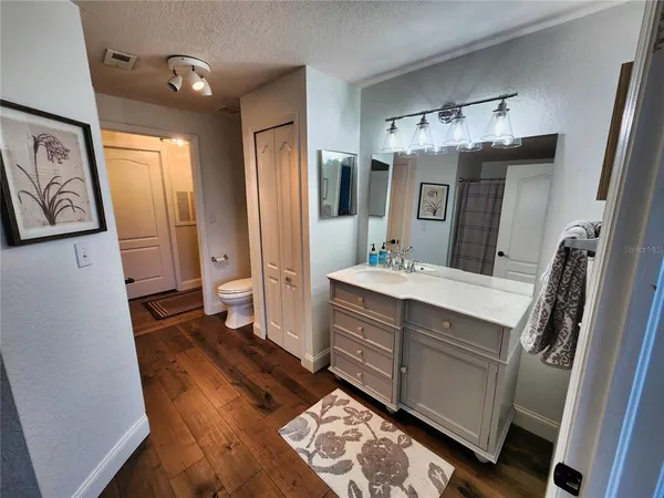 a bathroom with a sink a mirror and a shower