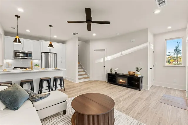a living room with furniture and kitchen view