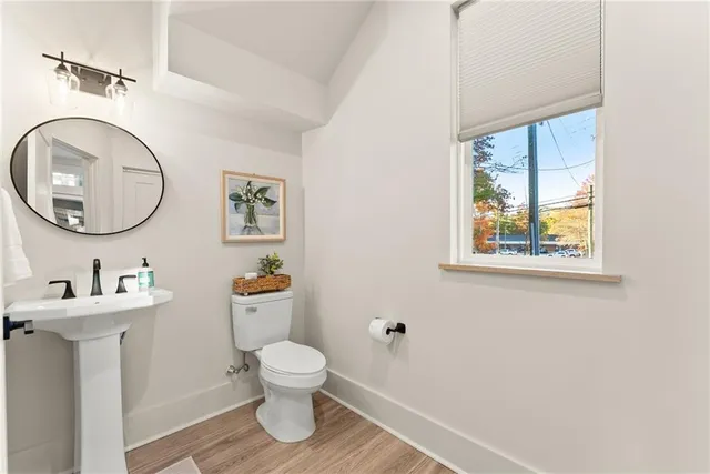 a bathroom with a toilet a sink and a mirror