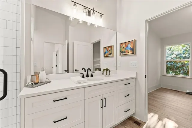 a bathroom with a double vanity sink and mirror
