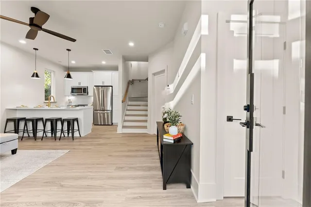 a hallway with a dining table and chairs