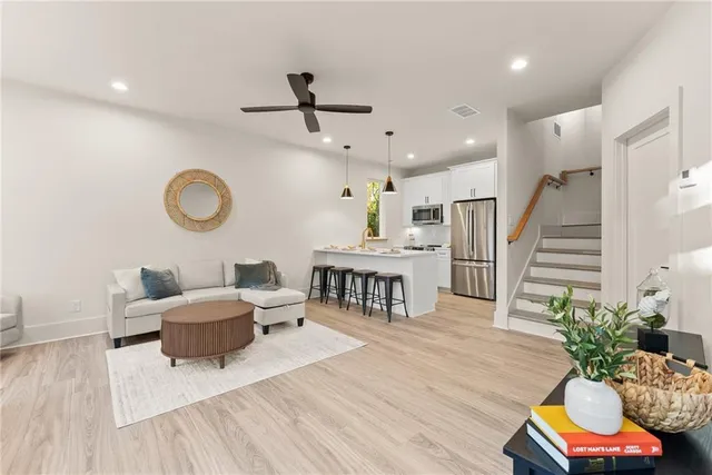 a living room with furniture and wooden floor