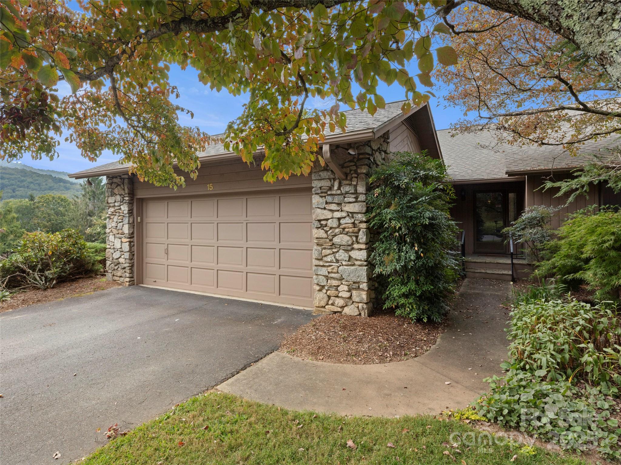 a view of a house with a yard and garage