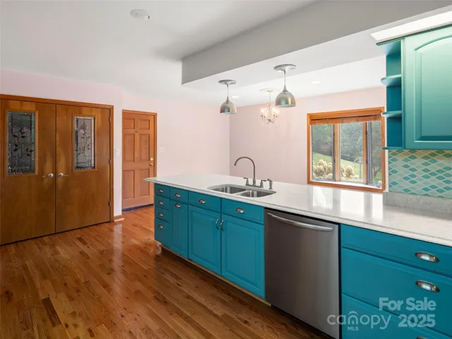 a kitchen with sink and large windows