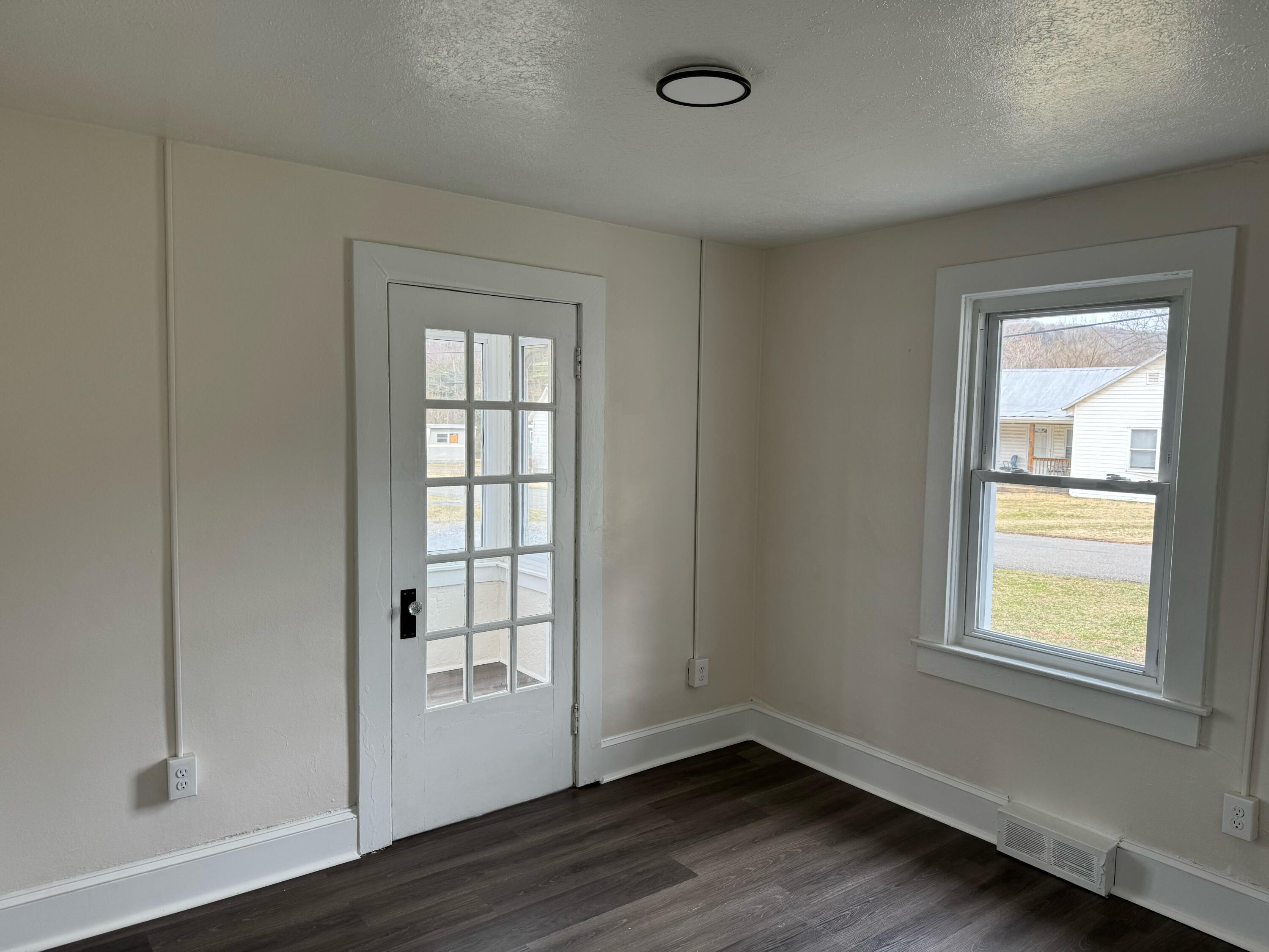 155 Brake Road Elliston, VA 24087 - Photo 5 of 19 an empty room with wooden floor and windows