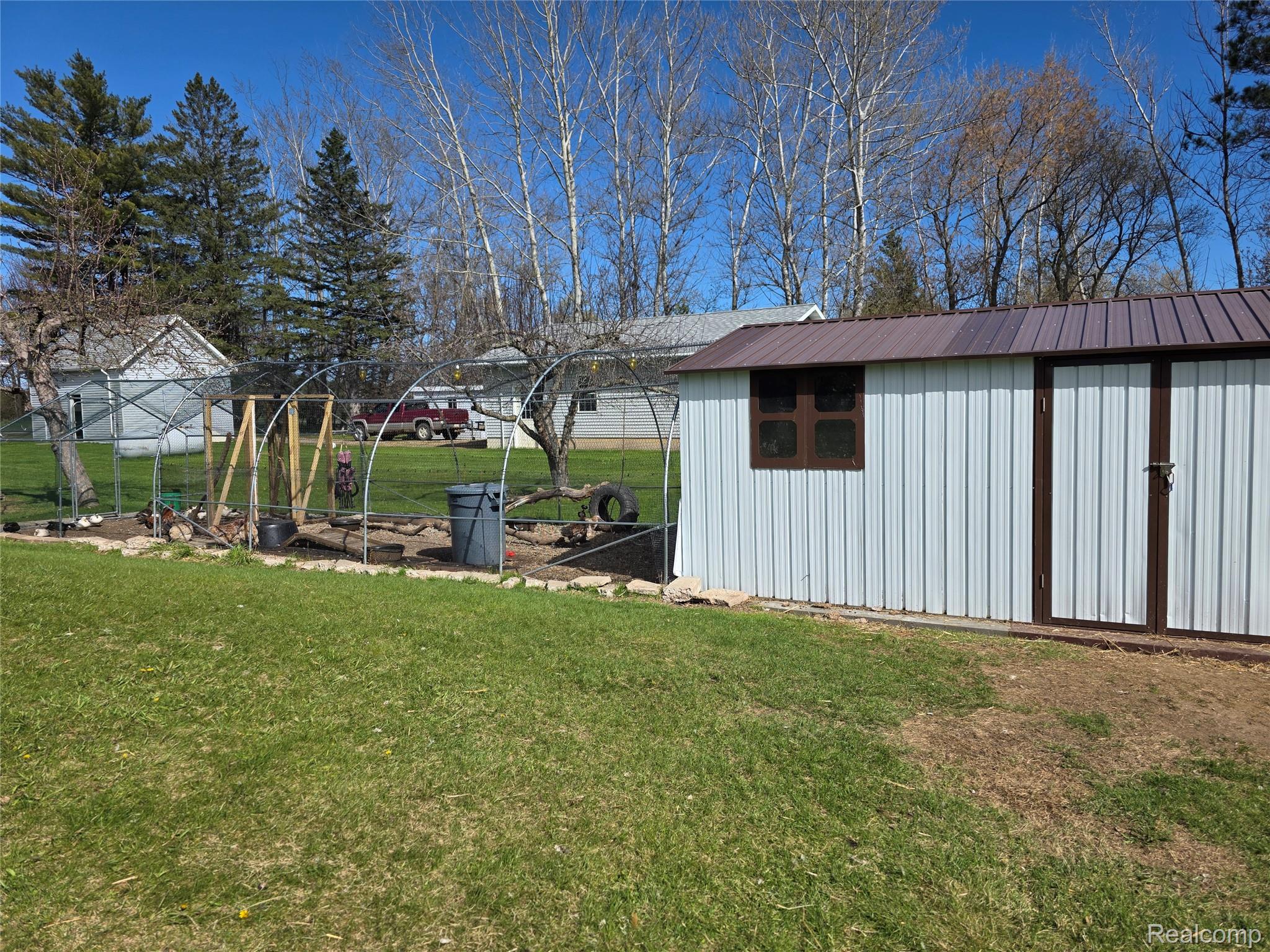5847 F Road Bark River, MI 49807 - Photo 2 of 25 View of grassy yard with an outbuilding