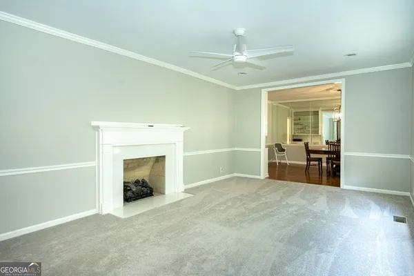 wooden floor fireplace and windows in an empty room