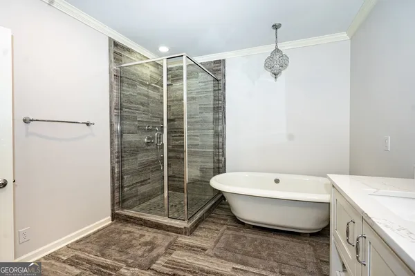 a spacious bathroom with a bathtub and shower