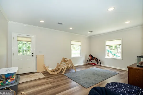 a living room with furniture a window and gym equipment