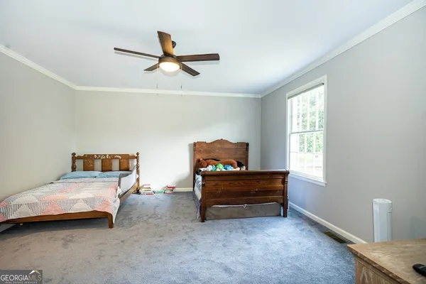 a bedroom with furniture and window