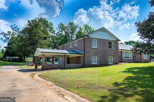 a view of a house with a yard porch and sitting area