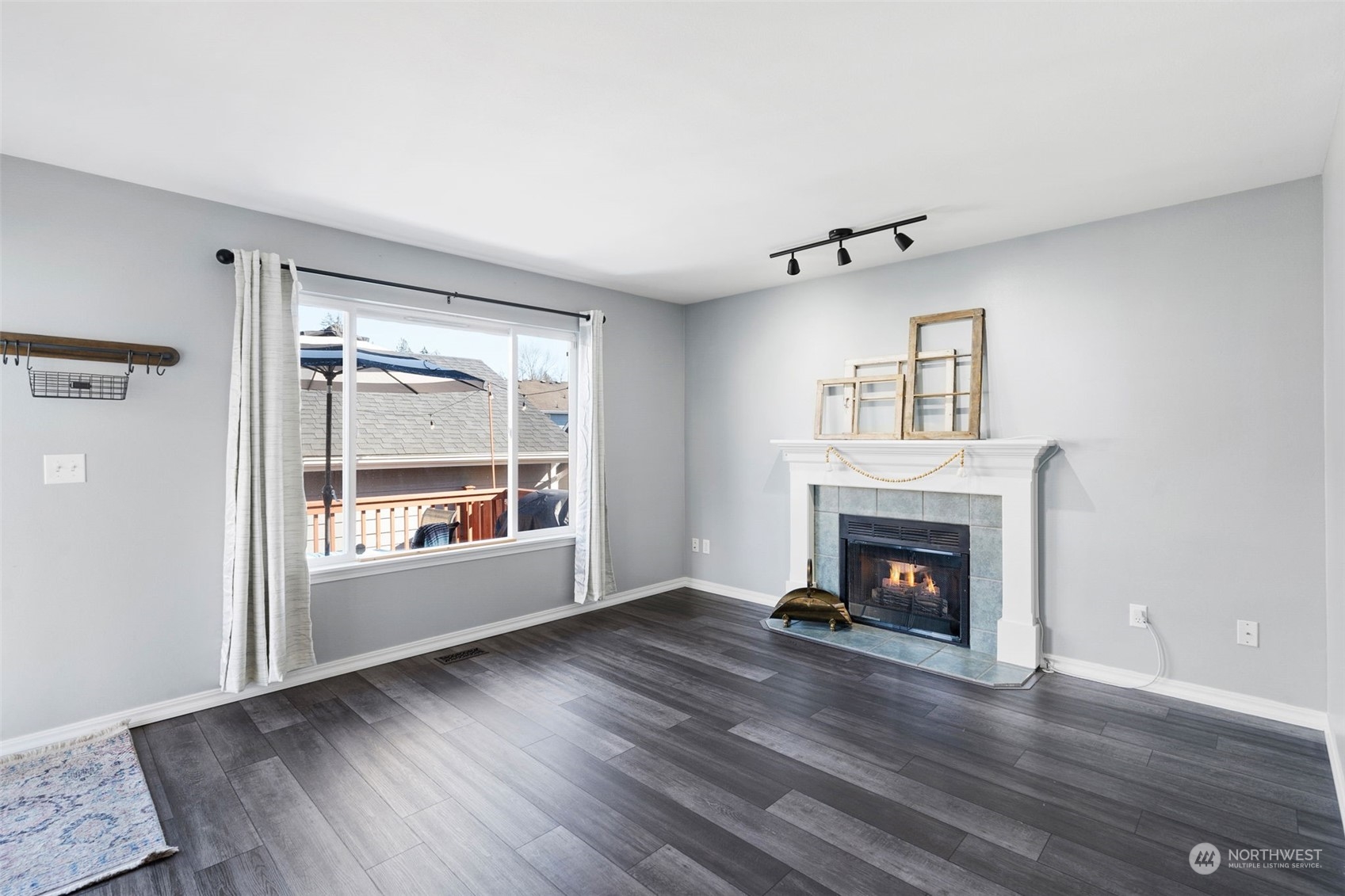 16887 Copper Mountain Road Southeast Monroe, WA 98272 - Photo 13 of 34 an empty room with wooden floor a fireplace and windows