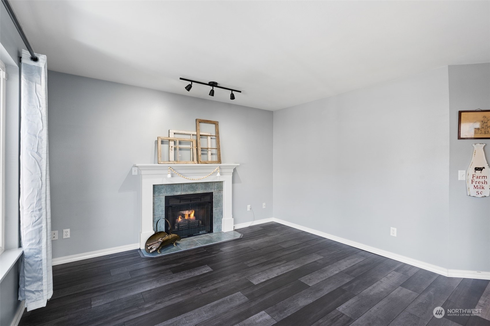 16887 Copper Mountain Road Southeast Monroe, WA 98272 - Photo 14 of 34 a view of an empty room with wooden floor and fireplace
