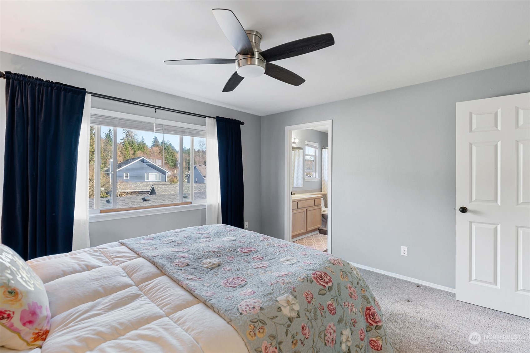 16887 Copper Mountain Road Southeast Monroe, WA 98272 - Photo 19 of 34 a bedroom with a large bed and a large window