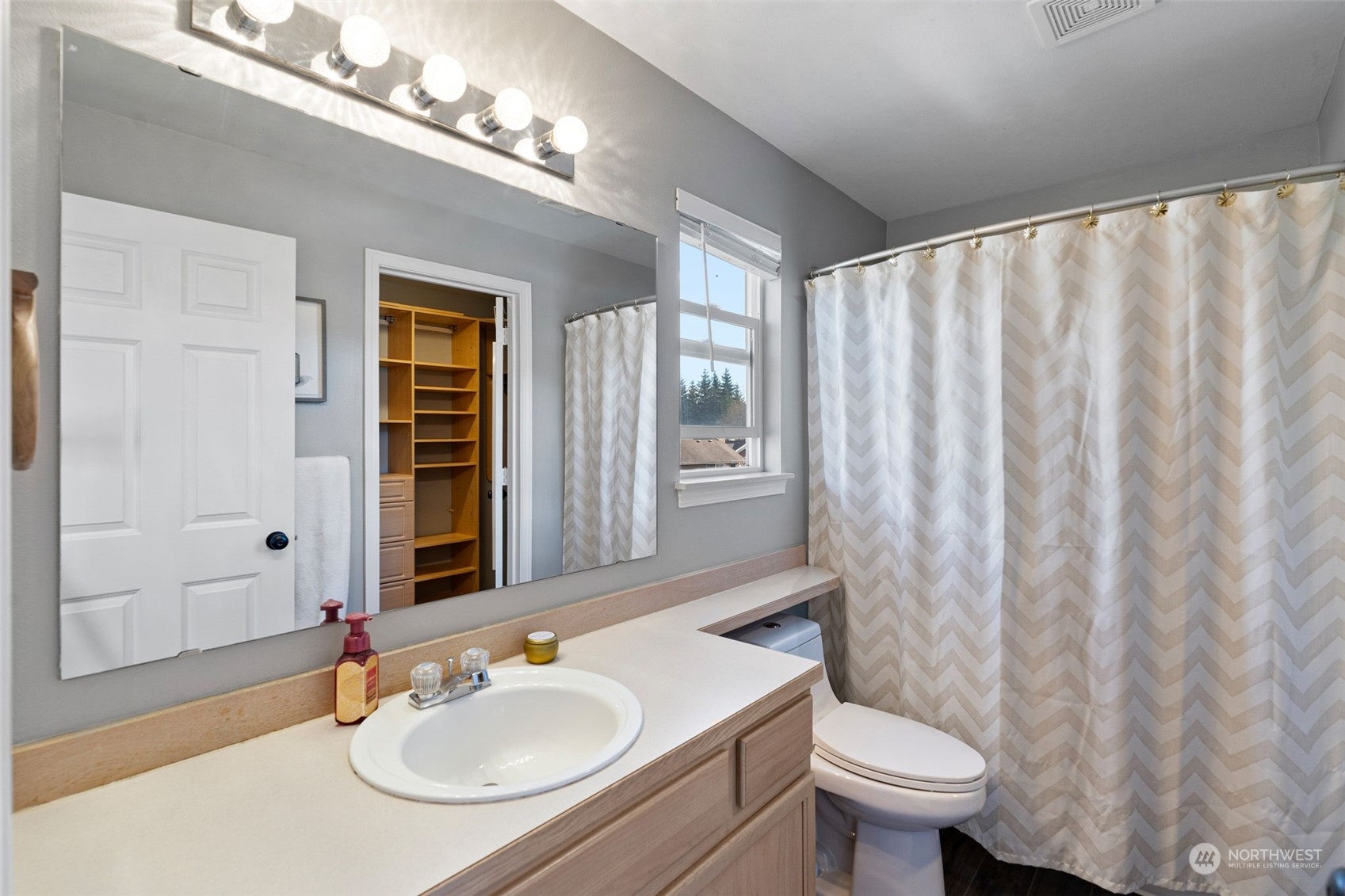 16887 Copper Mountain Road Southeast Monroe, WA 98272 - Photo 20 of 34 a bathroom with a sink toilet a mirror and shower curtain
