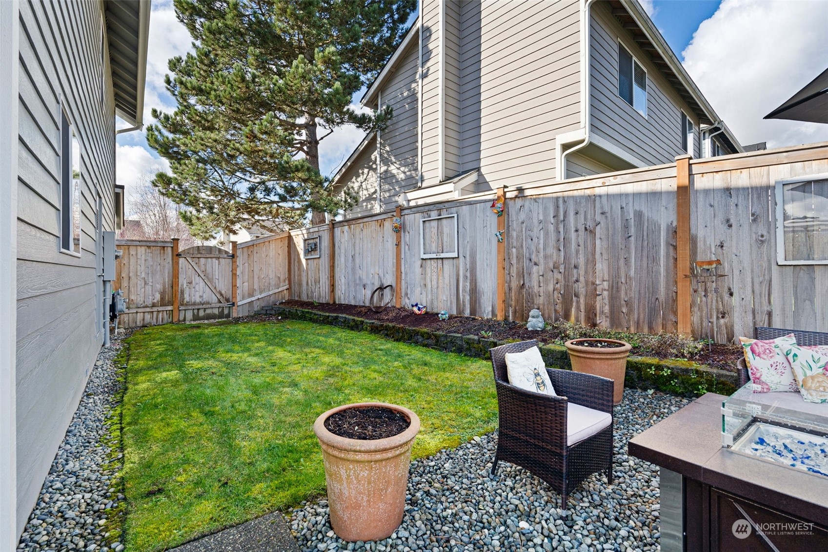 16887 Copper Mountain Road Southeast Monroe, WA 98272 - Photo 28 of 34 a view of a backyard with plants and a patio