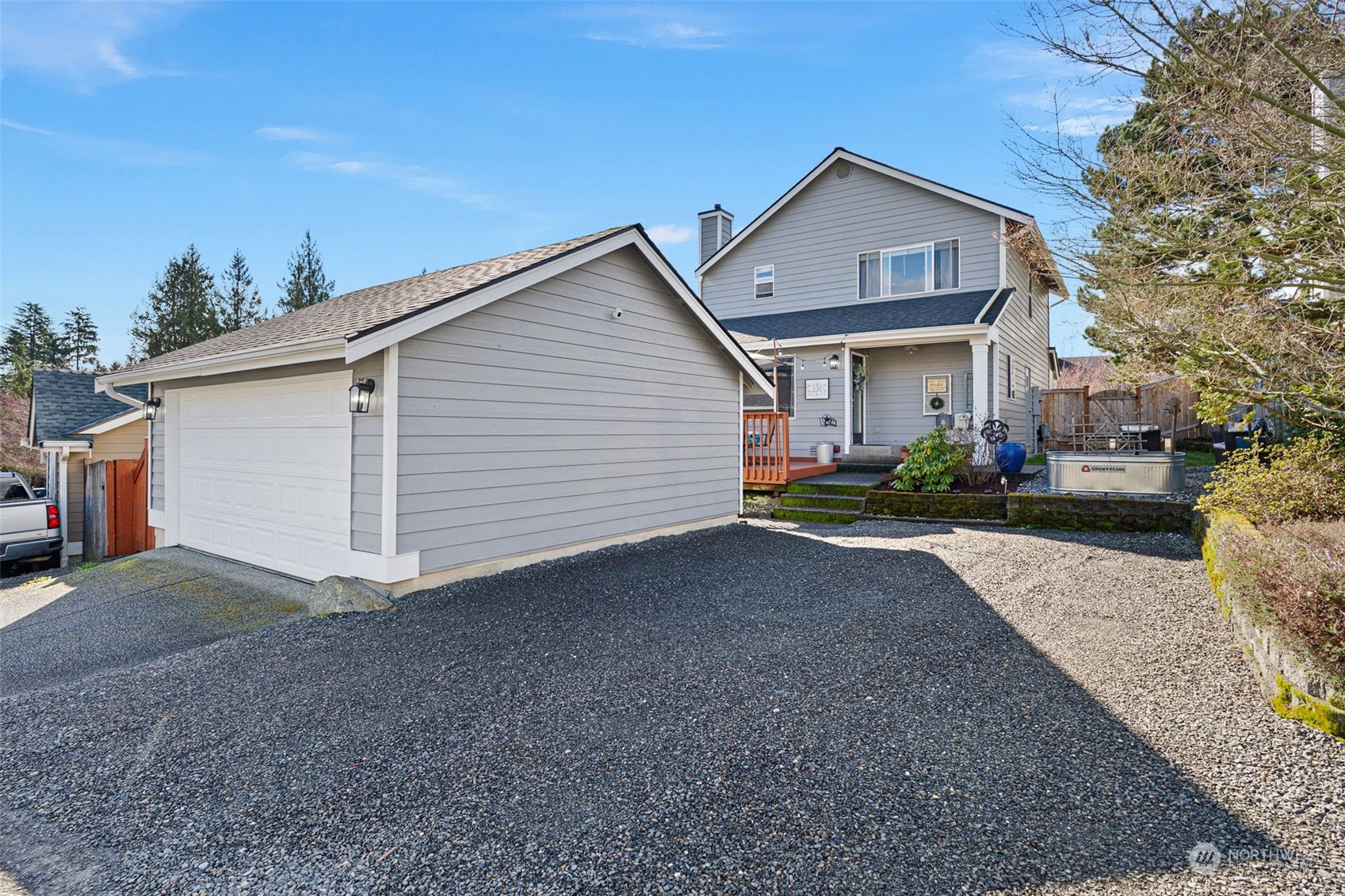 16887 Copper Mountain Road Southeast Monroe, WA 98272 - Photo 29 of 34 a view of a house with a yard and garage