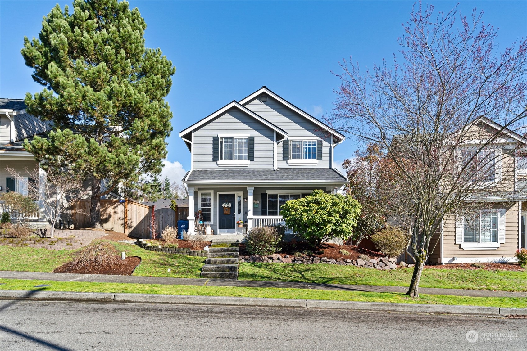 16887 Copper Mountain Road Southeast Monroe, WA 98272 - Photo 34 of 34 a front view of a house with a yard garage and outdoor seating