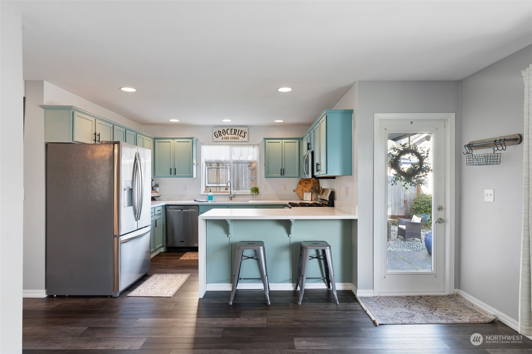16887 Copper Mountain Road Southeast Monroe, WA 98272 - Photo 9 of 34 a kitchen with stainless steel appliances granite countertop a refrigerator a stove and a wooden floors