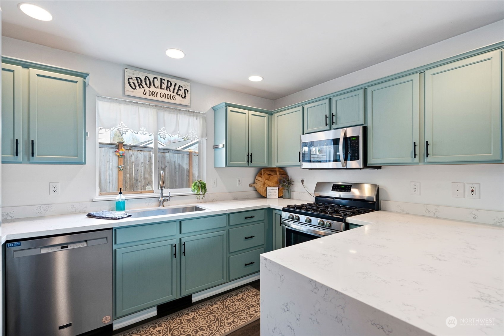16887 Copper Mountain Road Southeast Monroe, WA 98272 - Photo 10 of 34 a kitchen with stainless steel appliances a sink stove and microwave