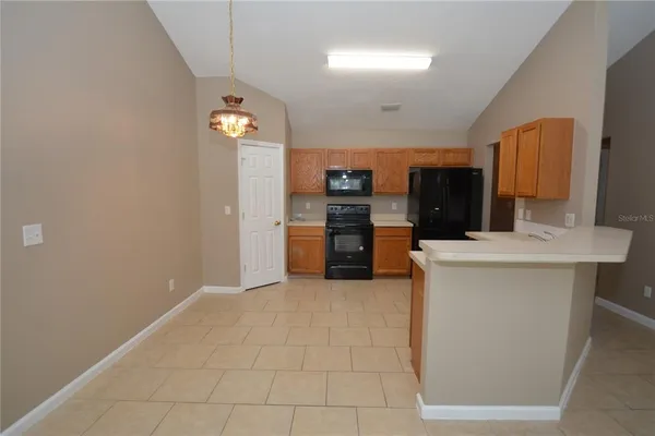 a kitchen with stainless steel appliances a refrigerator and a stove top oven