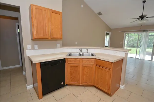 a kitchen with stainless steel appliances a stove top oven a sink dishwasher and a refrigerator