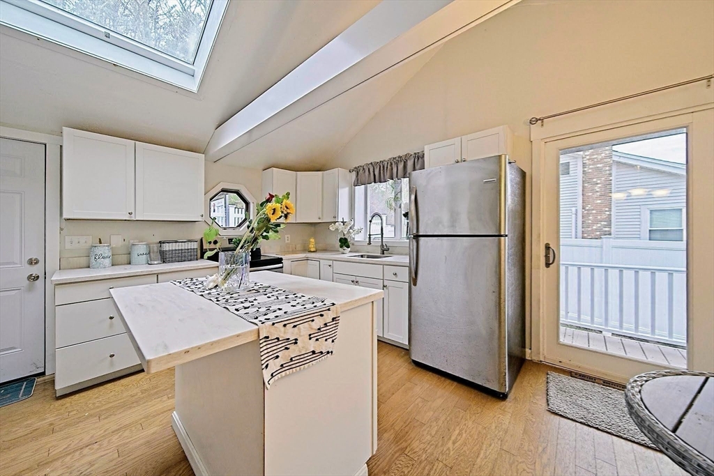 21 Hillside Road Plymouth, MA 02360 - Photo 34 of 39 a kitchen with stainless steel appliances granite countertop a refrigerator a stove a sink dishwasher and a refrigerator with wooden floor