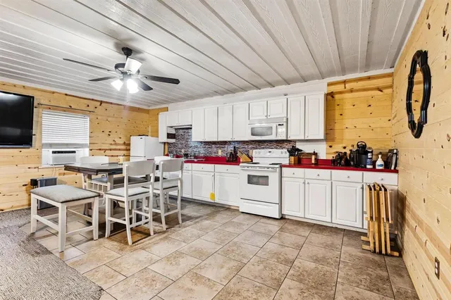 an aerial view of a house with a yard basket ball court and outdoor seating