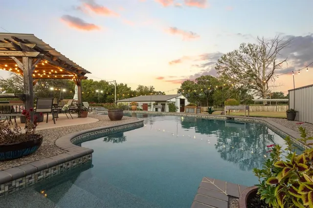 a view of swimming pool with outdoor seating and lake view