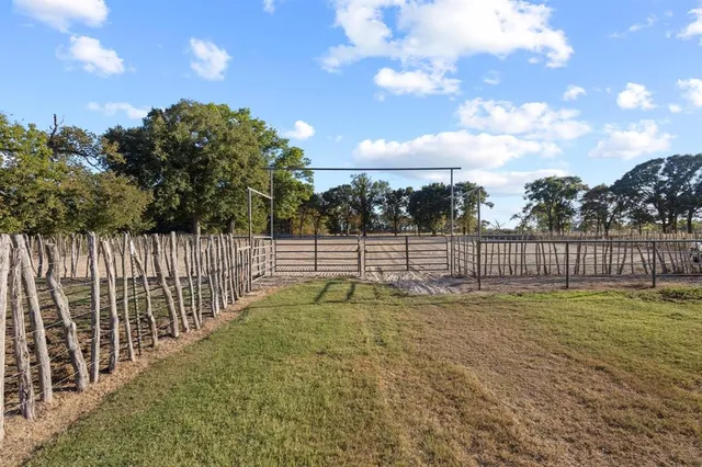 a view of yard with wooden fence