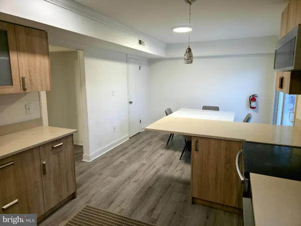 a kitchen with a sink cabinets and wooden floor