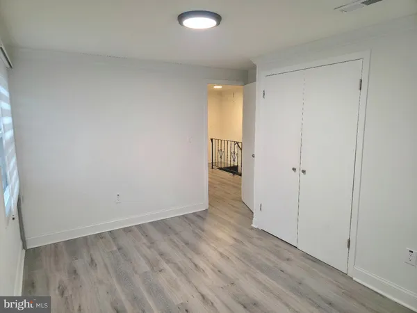 a view of an empty room and wooden floor