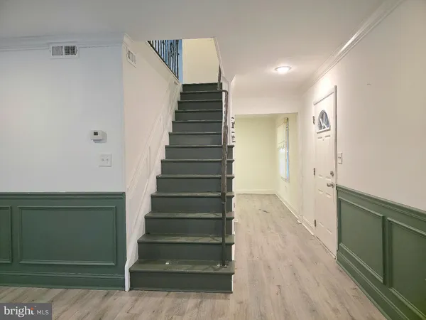 a view of entryway and hall with wooden floor