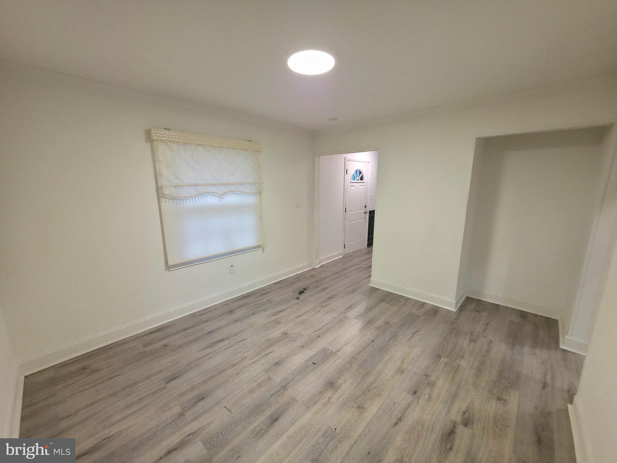 10 Melville Lane Willingboro, NJ 08046 - Photo 5 of 28 an empty room with wooden floor and windows